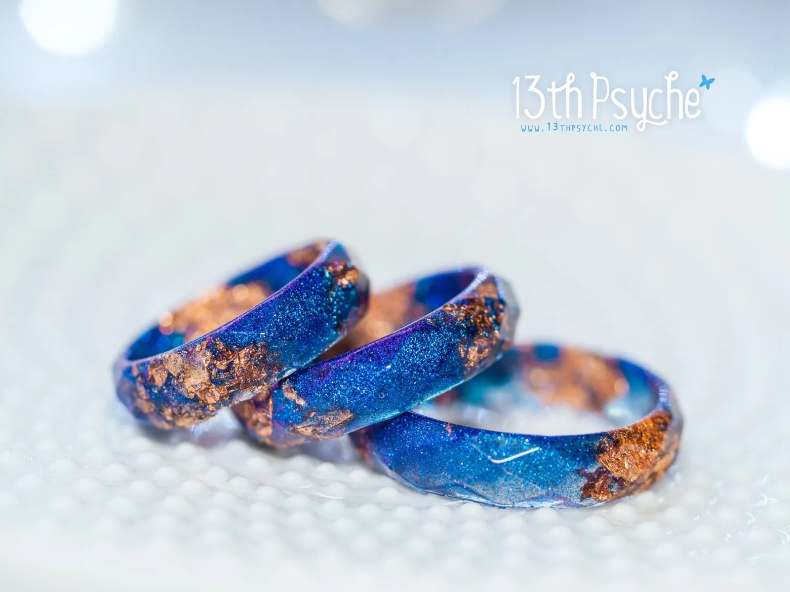 Iridescent blue faceted resin ring with rose gold flakes