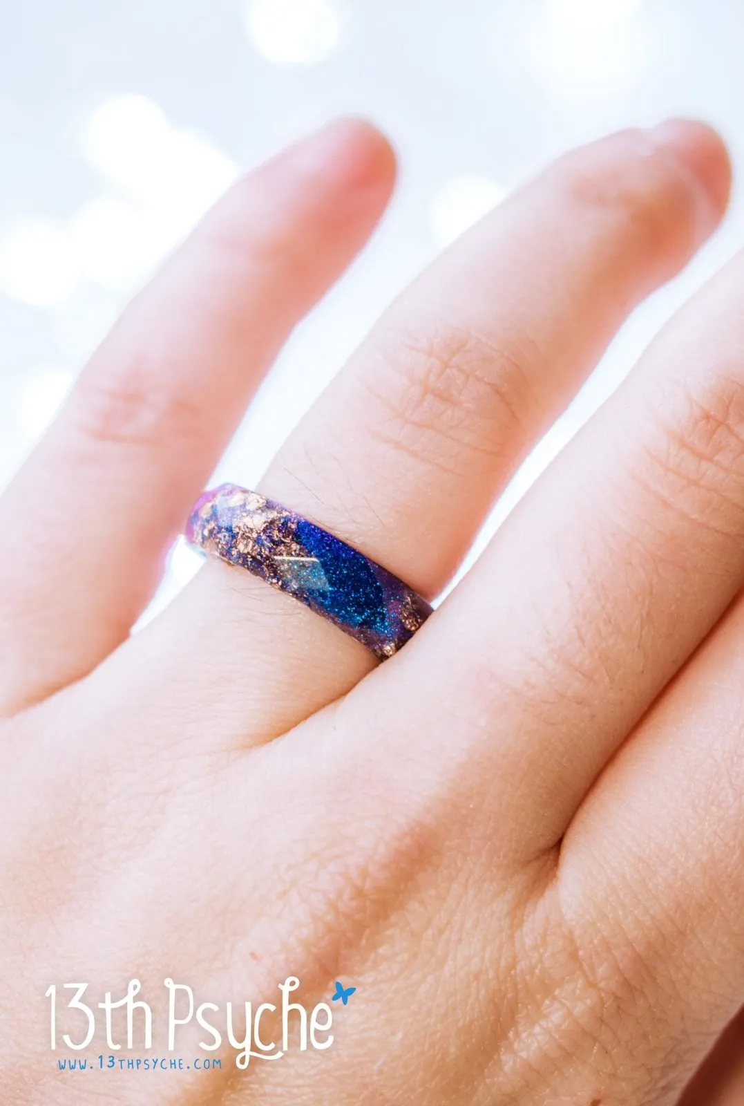 Iridescent blue faceted resin ring with rose gold flakes