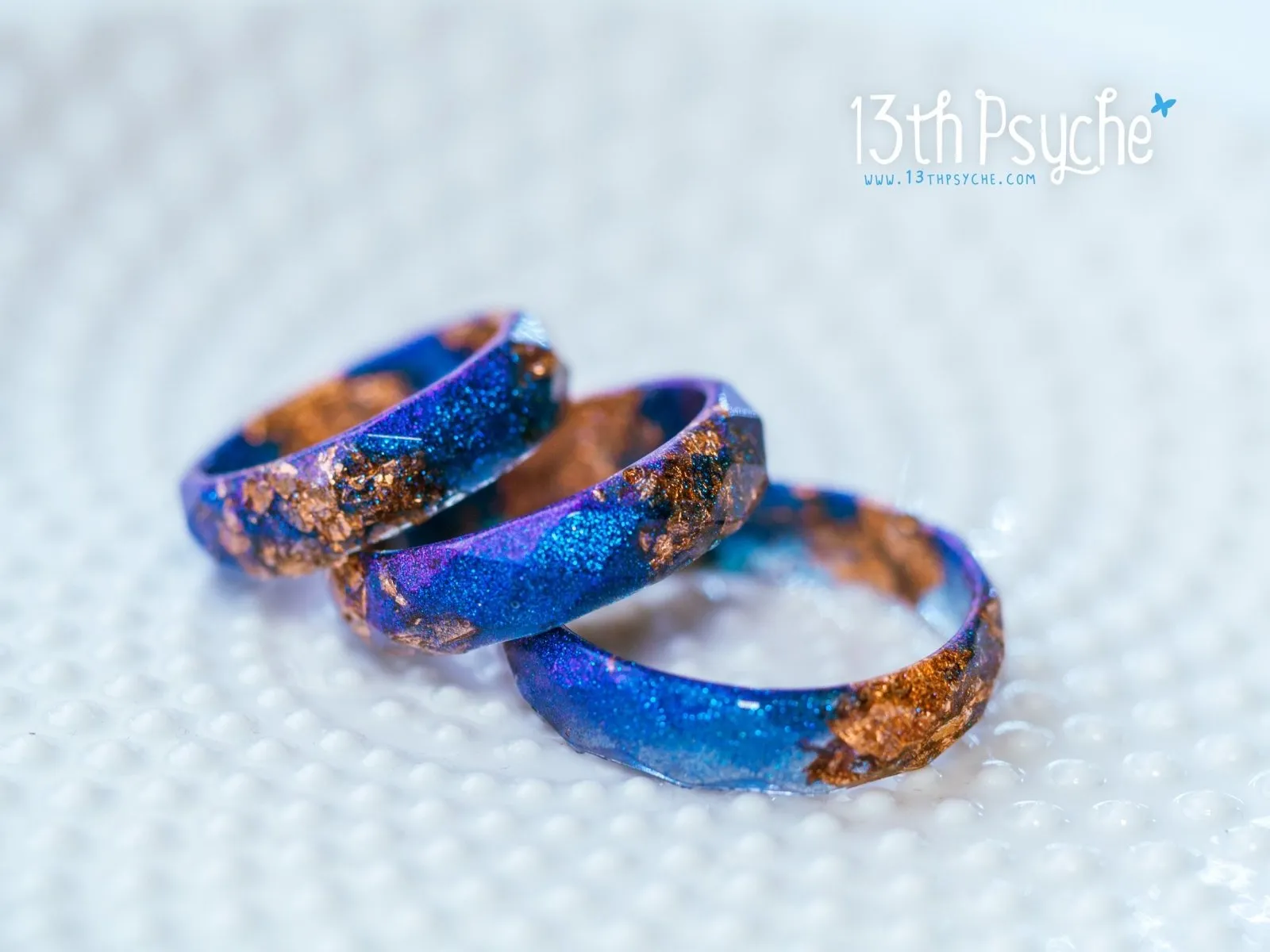 Iridescent blue faceted resin ring with rose gold flakes